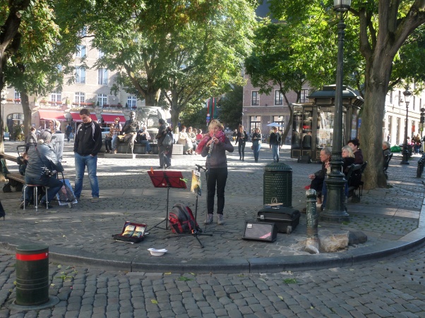Busker in Brussels. You need a licence and can only play in certain places.